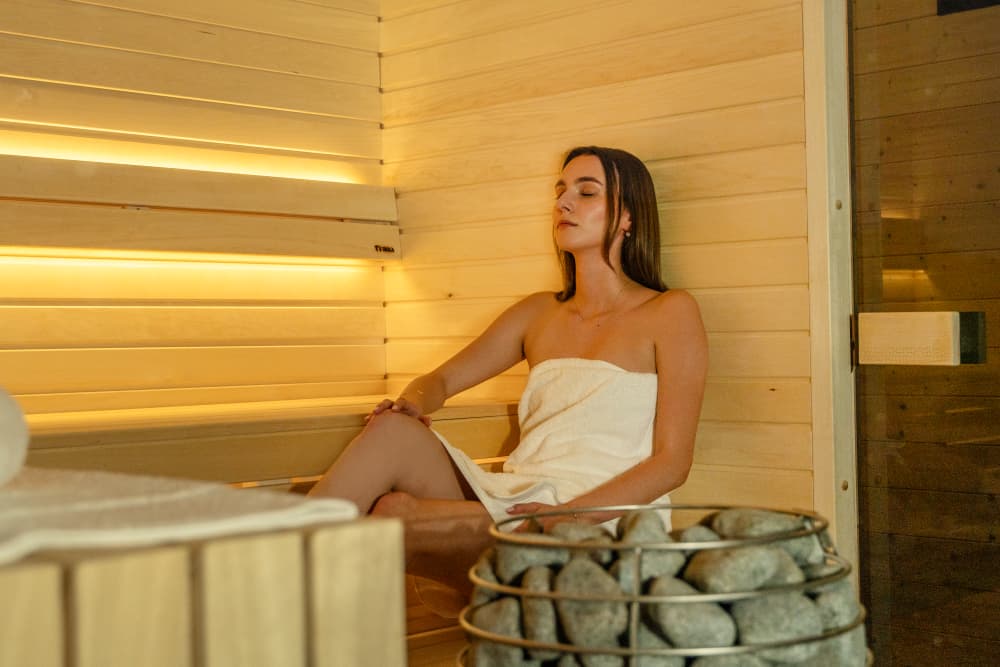 Dziewczyna relaksuje się w saunie VETTA - jednym z modeli dostępnych w ofercie TIKKA
